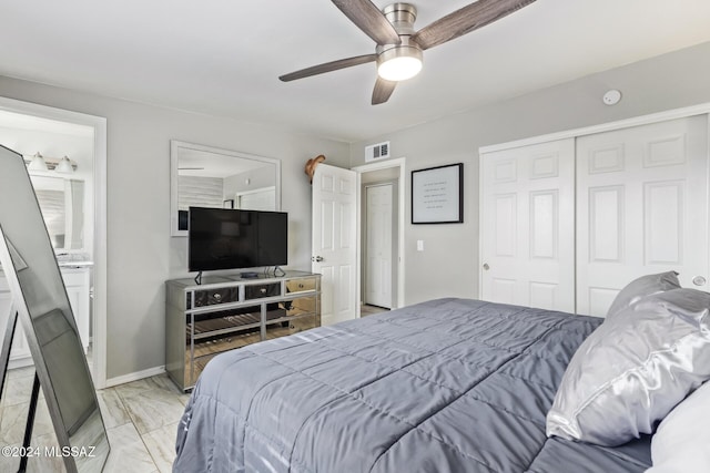 bedroom featuring ensuite bathroom, ceiling fan, and a closet