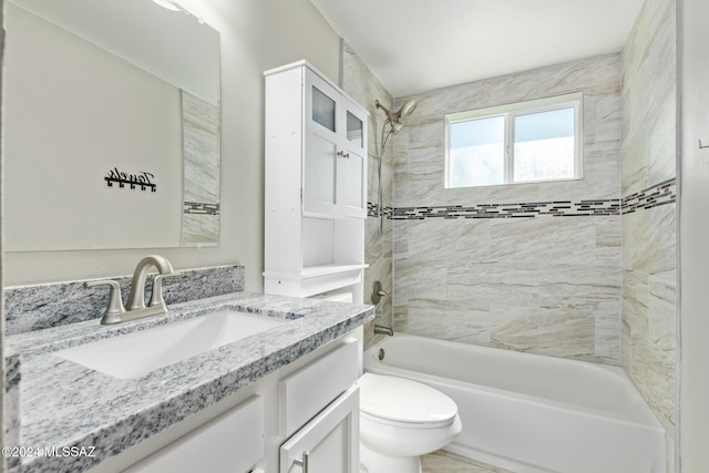 full bathroom featuring vanity, toilet, and tiled shower / bath combo