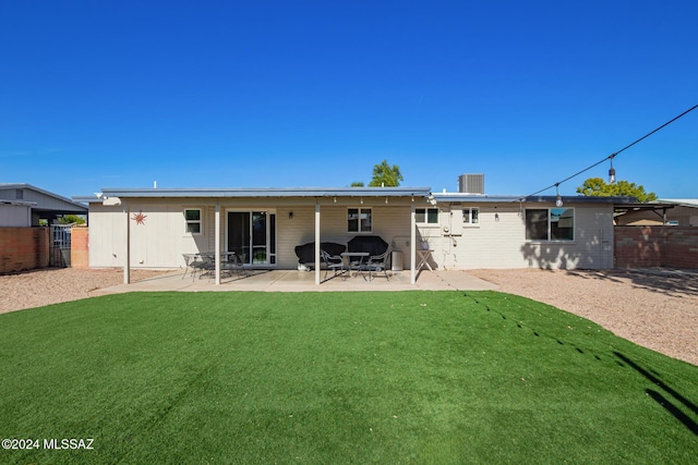 back of property featuring a lawn and a patio