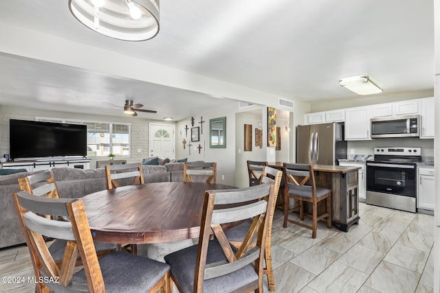 dining space featuring ceiling fan