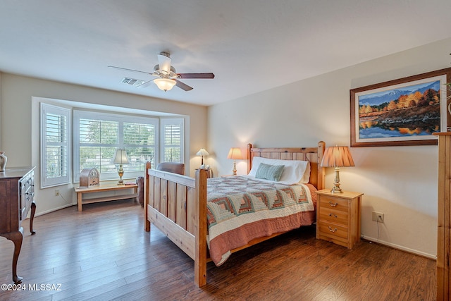 bedroom with ceiling fan and dark hardwood / wood-style flooring