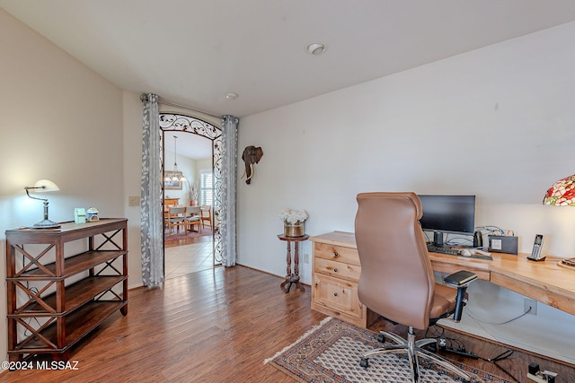 office space with hardwood / wood-style floors and lofted ceiling