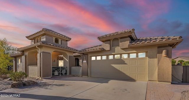 mediterranean / spanish house featuring a garage