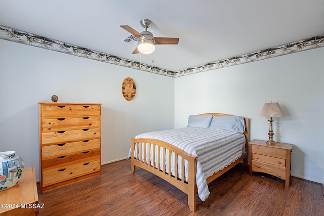 bedroom with ceiling fan and dark wood-type flooring