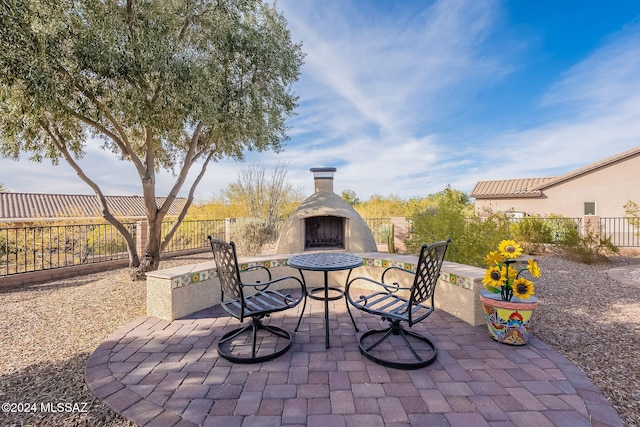 view of patio with exterior fireplace