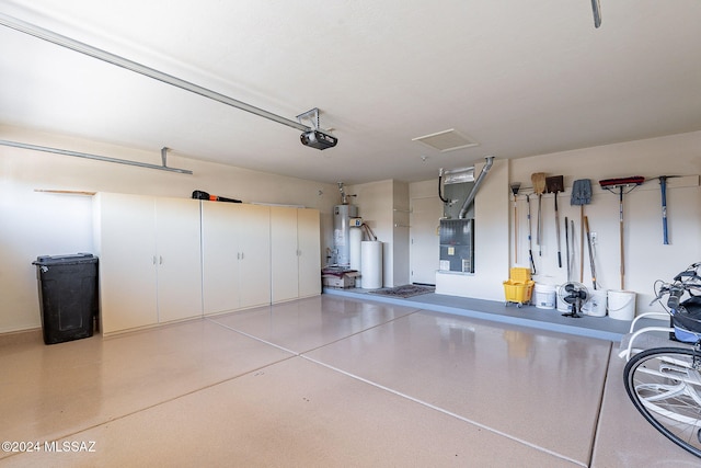 garage featuring water heater and a garage door opener