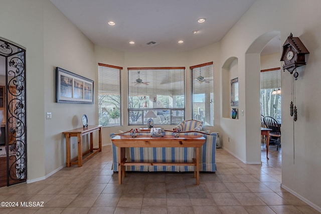 tiled dining space with ceiling fan