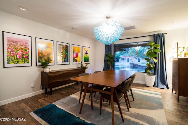 dining room featuring hardwood / wood-style floors and an inviting chandelier