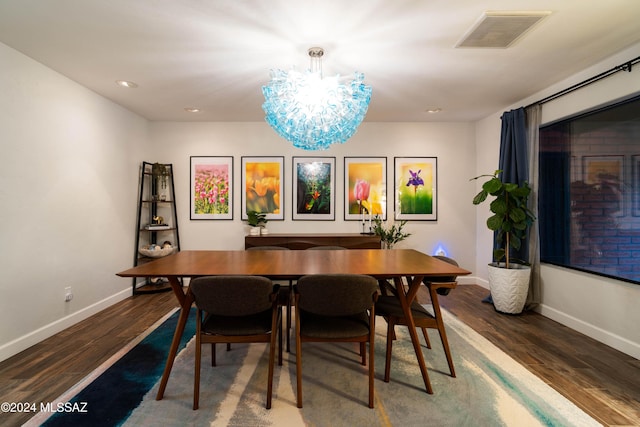 dining room with a notable chandelier and dark hardwood / wood-style floors