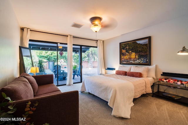 bedroom featuring access to exterior, light carpet, multiple windows, and ceiling fan