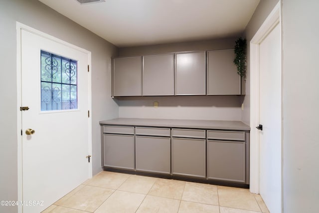 kitchen featuring gray cabinetry and light tile patterned floors