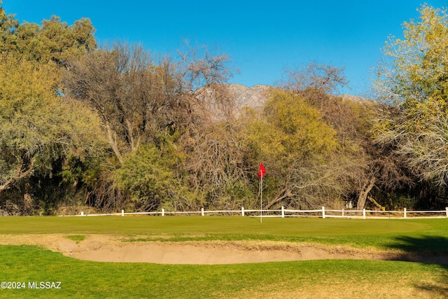 view of property's community with a rural view and a lawn