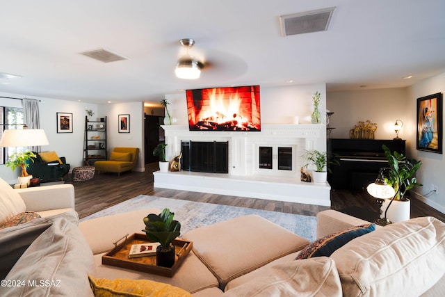 living room with a fireplace, hardwood / wood-style floors, and ceiling fan