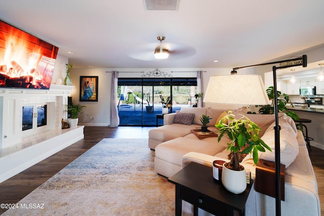 living room featuring dark hardwood / wood-style floors and ceiling fan