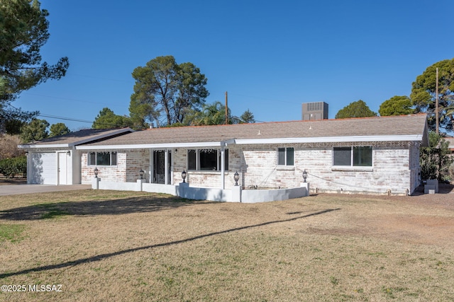 single story home featuring an attached garage, a front lawn, and brick siding