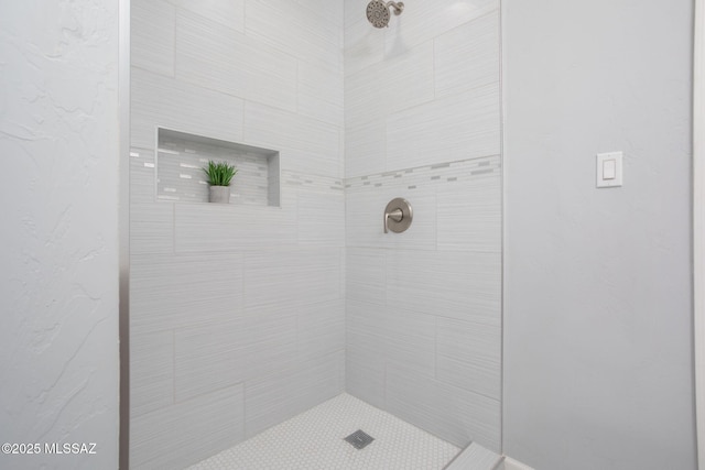 bathroom with tiled shower