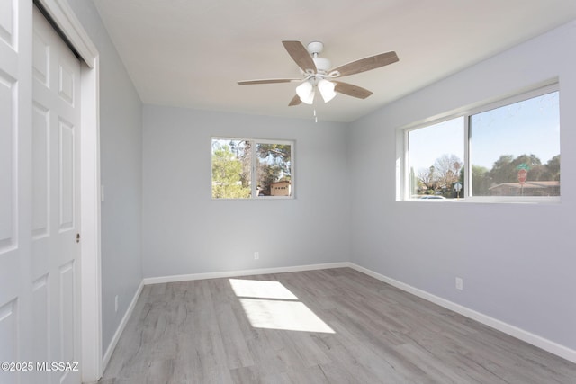 unfurnished bedroom with light hardwood / wood-style floors, ceiling fan, and a closet