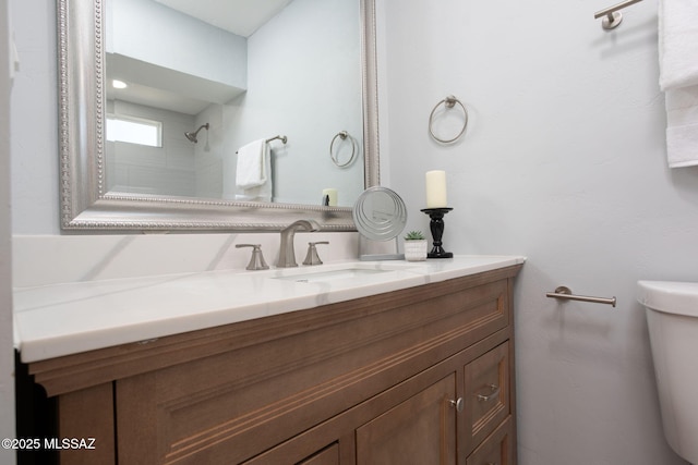 full bathroom featuring vanity, toilet, and walk in shower