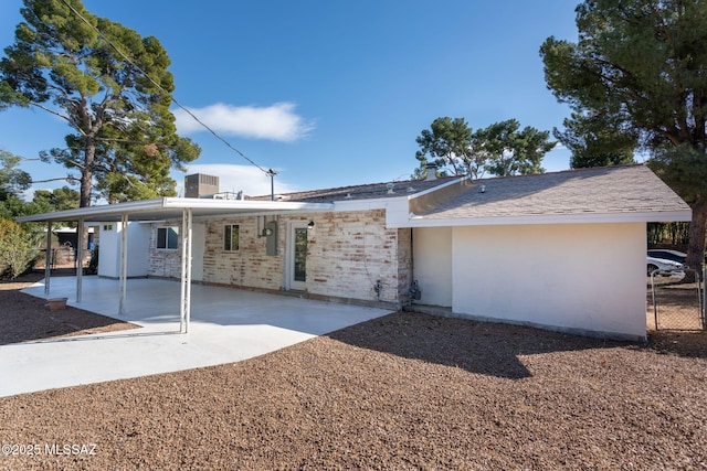 rear view of property with central AC unit