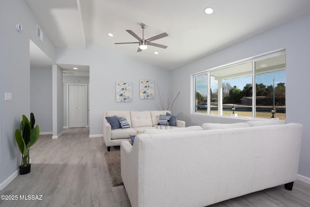 living room with lofted ceiling, light wood-type flooring, and ceiling fan