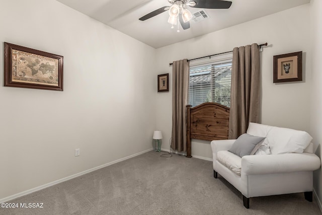 living area with light colored carpet and ceiling fan