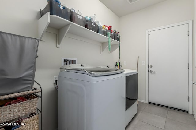 laundry area featuring independent washer and dryer and light tile patterned floors