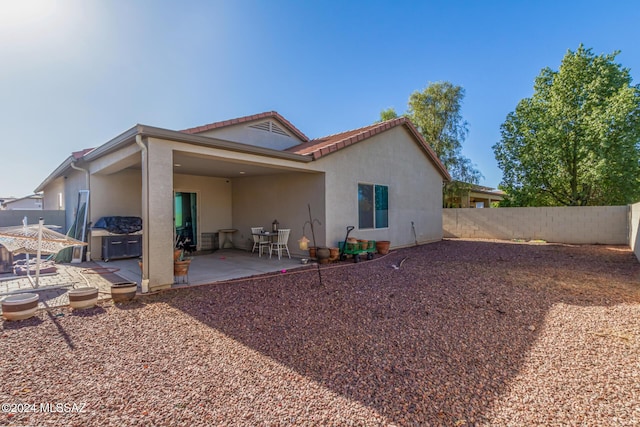 rear view of house with a patio