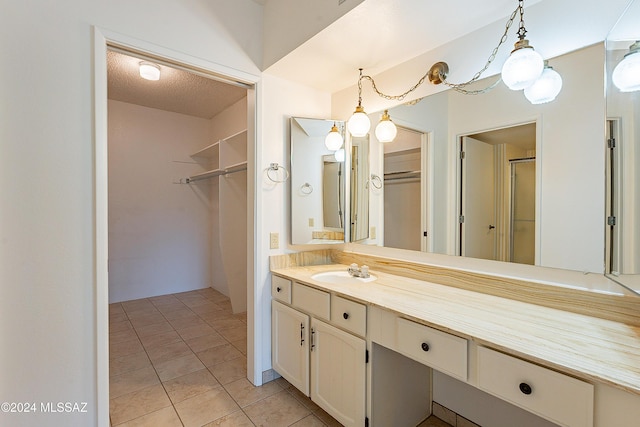 bathroom featuring vanity, a textured ceiling, and tile patterned floors