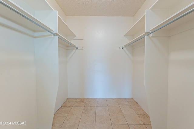 spacious closet with light tile patterned floors