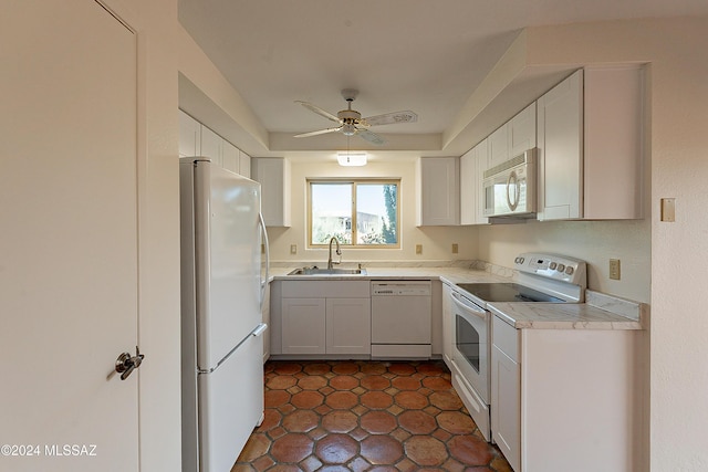 kitchen featuring ceiling fan, sink, dark tile patterned floors, white appliances, and white cabinets