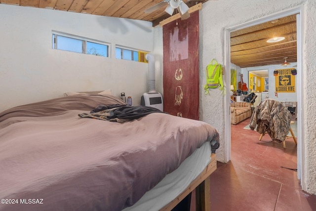 bedroom with concrete flooring, ceiling fan, wood ceiling, and lofted ceiling