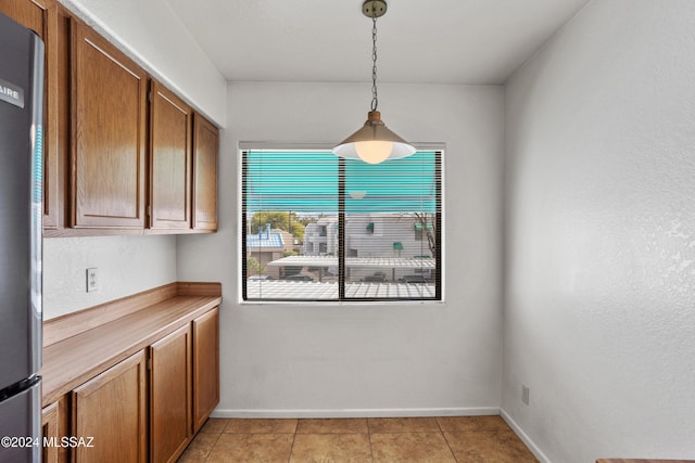 unfurnished dining area with light tile patterned floors