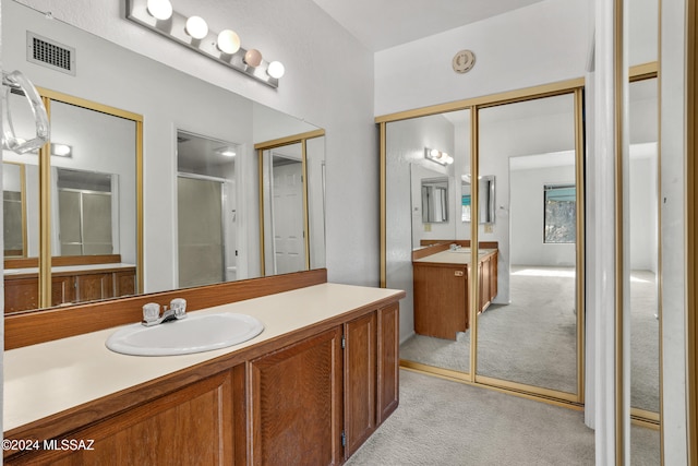 bathroom with vanity and an enclosed shower