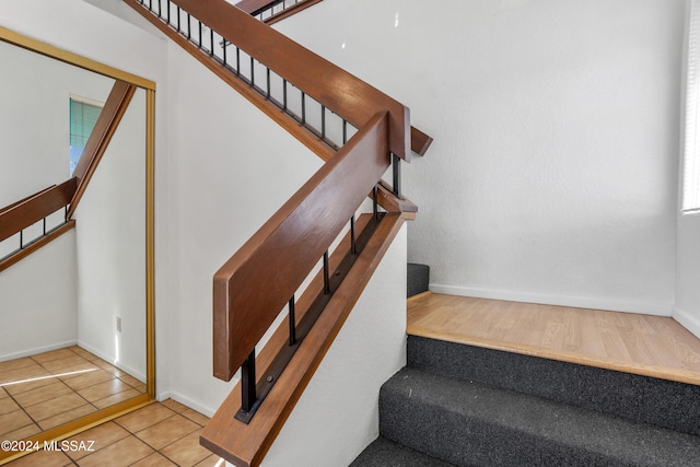 staircase with tile patterned floors