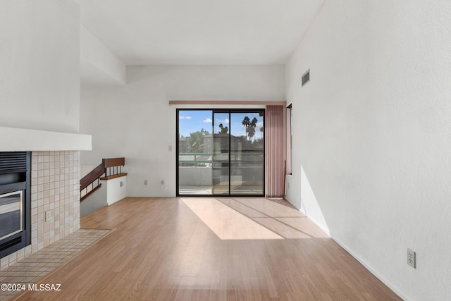 unfurnished living room with a fireplace and light hardwood / wood-style flooring