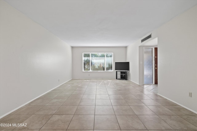 unfurnished living room with light tile patterned floors