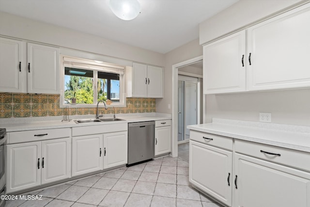 kitchen featuring white cabinetry, sink, tasteful backsplash, stainless steel dishwasher, and light tile patterned floors