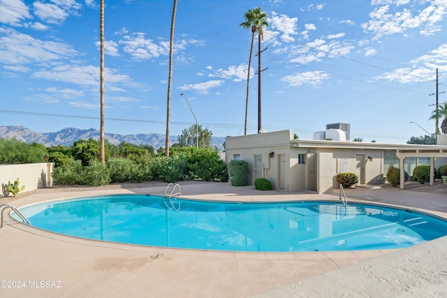 view of pool with a mountain view and a patio