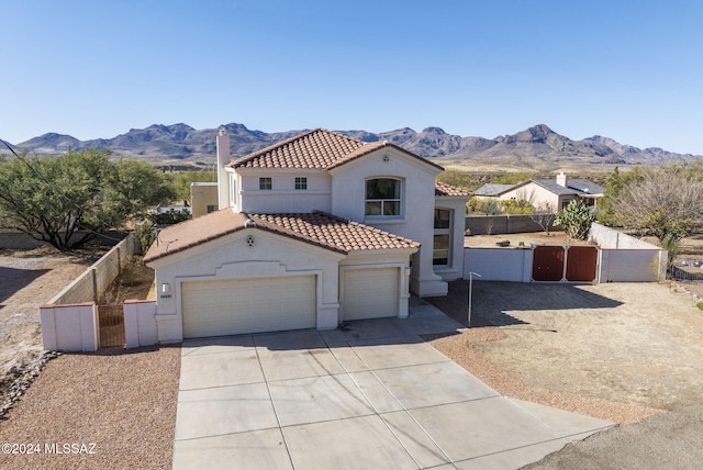 view of front facade with a mountain view and a garage