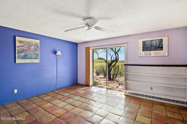 spare room featuring tile patterned flooring, a textured ceiling, and ceiling fan