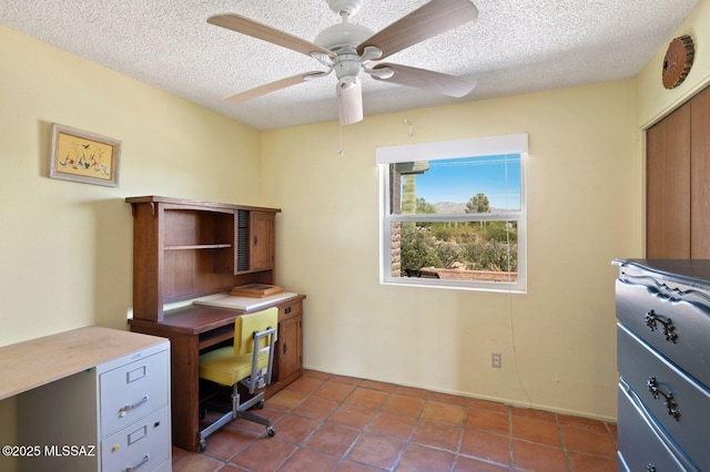 tiled home office with a textured ceiling and ceiling fan