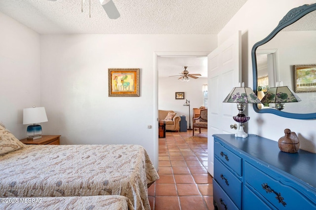 tiled bedroom with a textured ceiling and ceiling fan