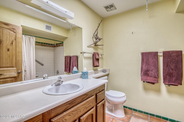 bathroom with tile patterned floors, vanity, and toilet