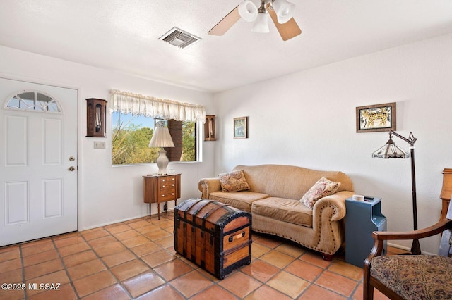 tiled living room with ceiling fan