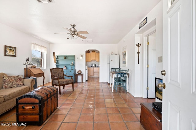 tiled living room featuring ceiling fan