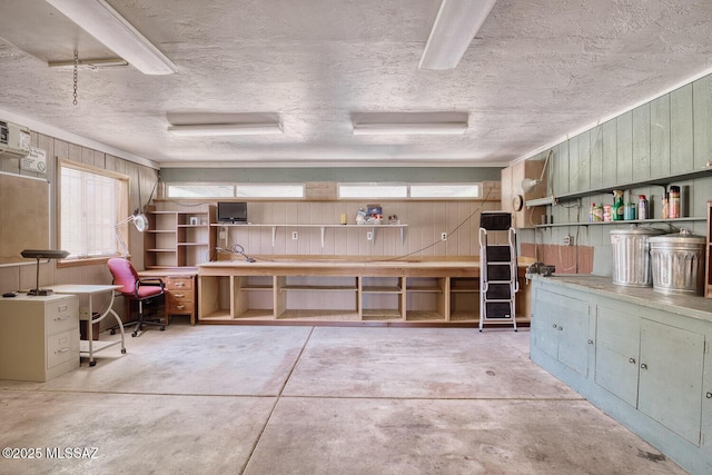 interior space featuring a workshop area and wooden walls