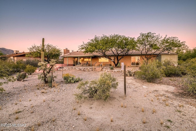 back house at dusk with a patio