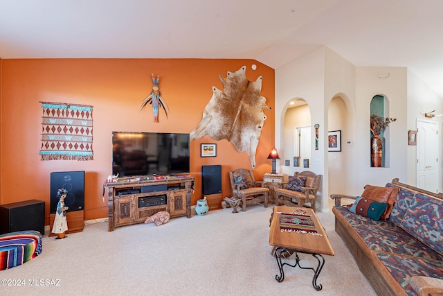 carpeted living room featuring vaulted ceiling