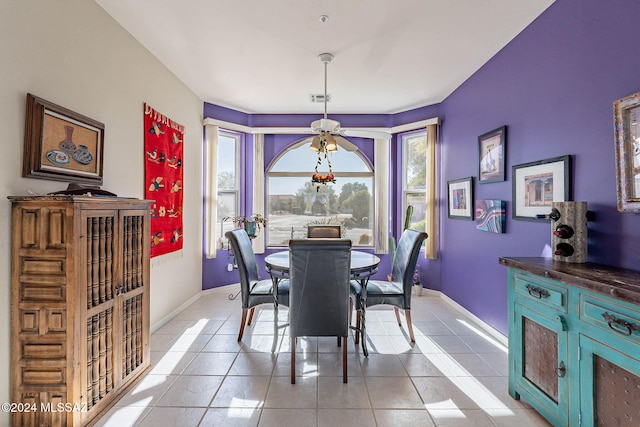 dining area featuring light tile patterned flooring, visible vents, and baseboards