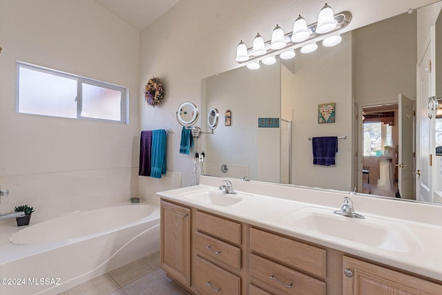 full bathroom featuring double vanity, a sink, a bath, and tile patterned floors